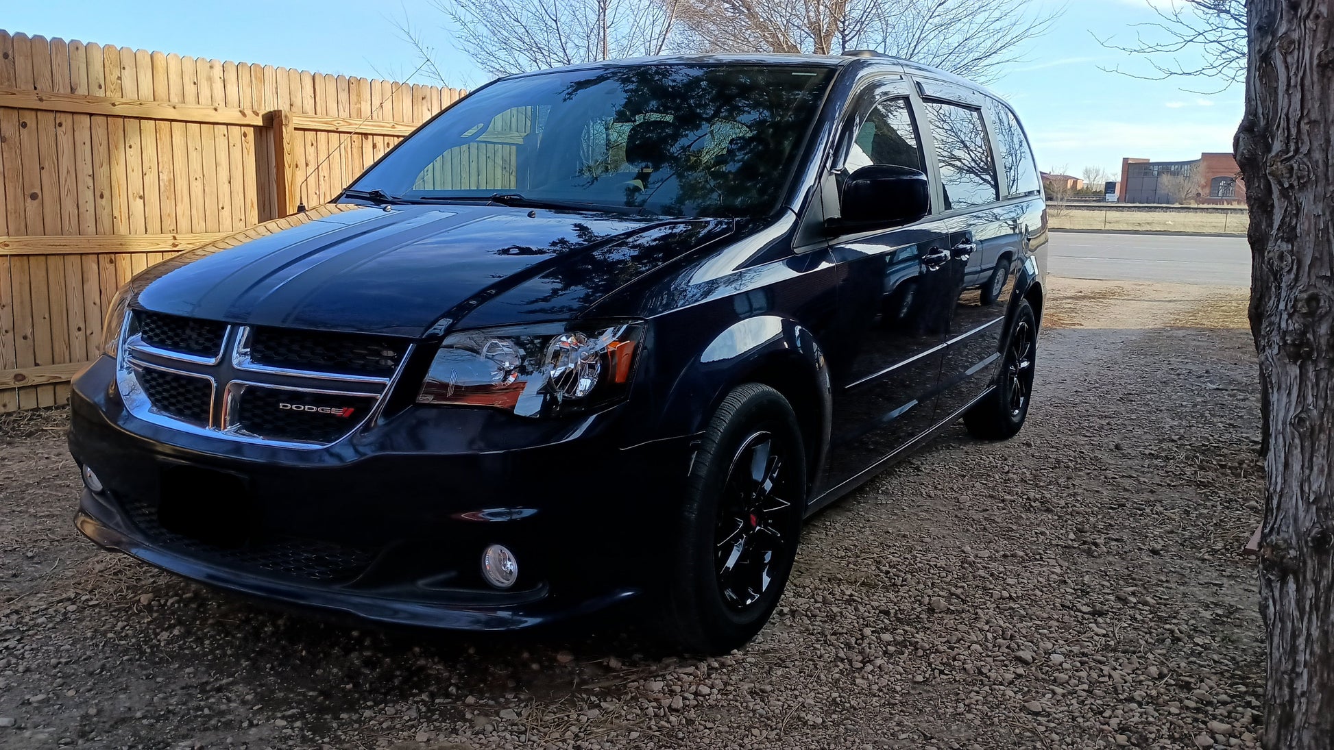 Black dodge caravan with wheel spacers